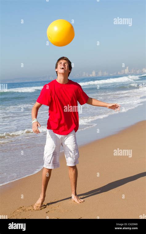 Teen Boy Playing Beach Ball On Beach Photo Stock Alamy
