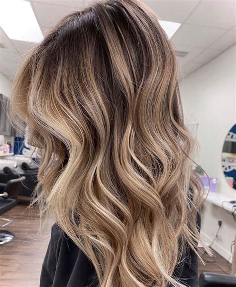 stunning neutral toned balayage and beach waves love the medium brown fading into buttery bl