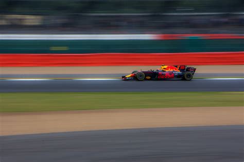 A Red Bull Racing Car Speeding Down The Track