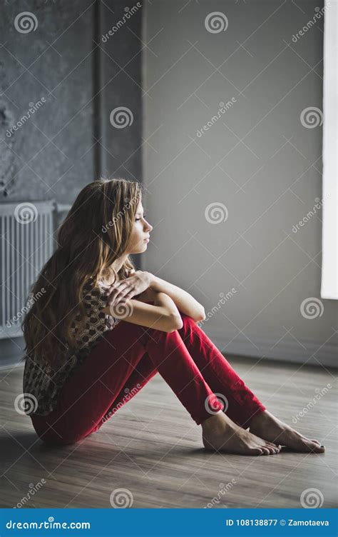 The Girl Sitting On The Floor Hugging His Knees 6960 Stock Image