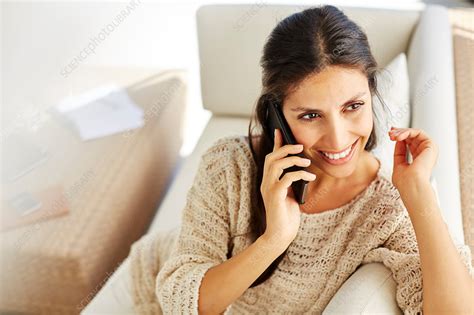 Smiling Woman Talking On Cell Phone On Sofa Stock Image F0171536