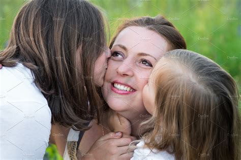 Two Daughters Kiss Mom People Images ~ Creative Market