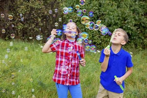 Kids Playing With Bubbles Stock Photo Image Of Meadow 104953950