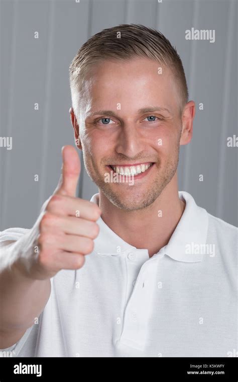 Portrait Of Young Man Showing Thumbs Up Sign Stock Photo Alamy