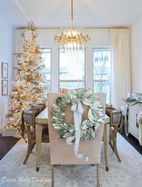 A Dining Room Table With A Wreath On It And A Christmas Tree In The