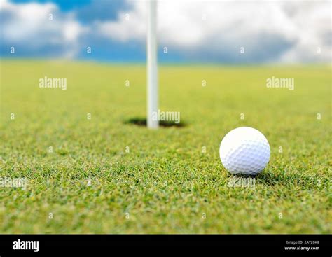 Golf Ball At Hole On Grass Field Stock Photo Alamy