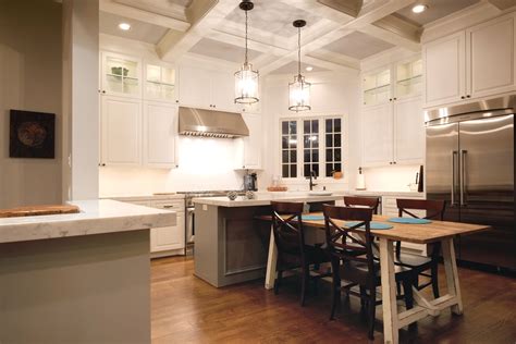 White Kitchen W Contrast Island Pendant Lighting Wood Floors And Exposed Beam Ceilings