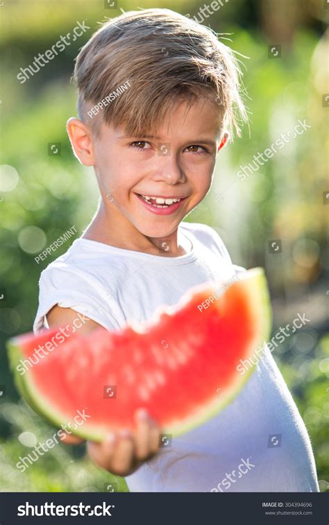 Funny Kid Eating Watermelon Outdoors In Summer Park Focus
