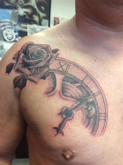 The rose is a powerful symbol that has been adorned by generations of manly men from sailors out on the rough seas, to soldiers taking their last breath on the battlefields. chest tattoo, black and grey shade, clockwork, rose, men ...