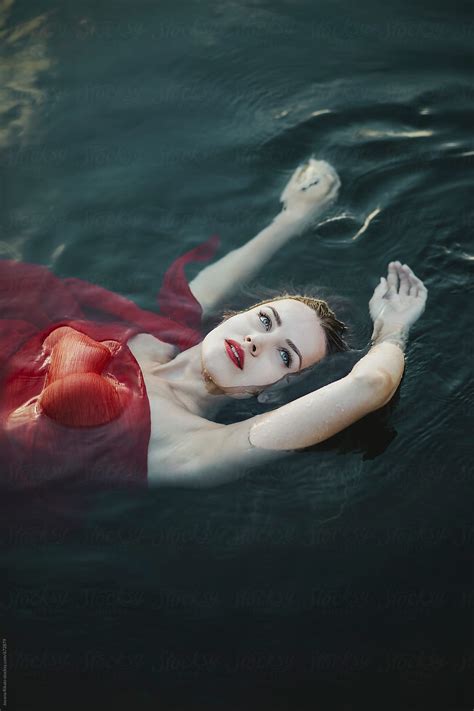 Beautiful Woman Floating On Water By Stocksy Contributor Jovana