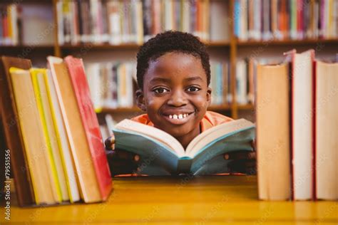 Cute African American Boy Reading Book In Library Stock Photo Adobe Stock