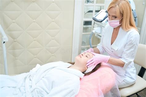Woman Beautician Makes Face Massage To Girl In Beautician Office Stock Image Image Of