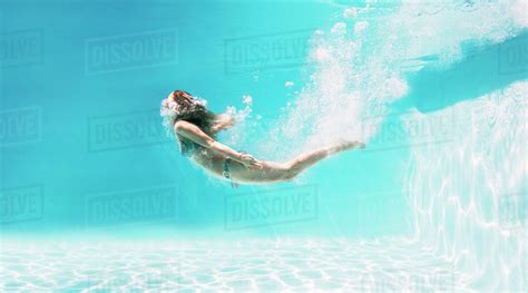 Woman Swimming Underwater In Swimming Pool Stock Photo Dissolve