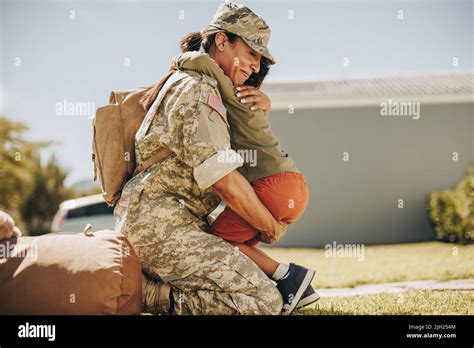 Military Mom Embracing Her Son After Returning Home From The Army Courageous Female Soldier
