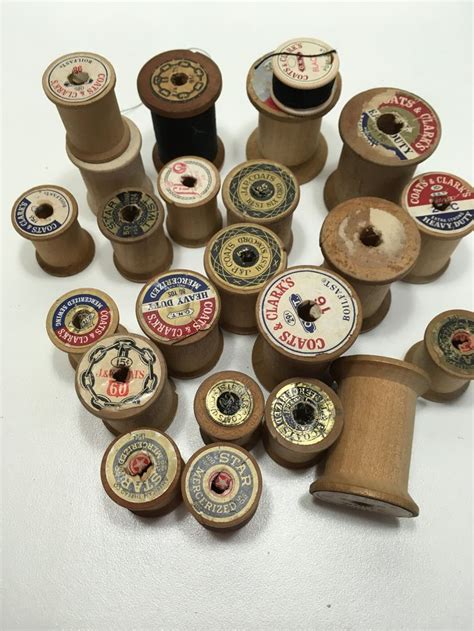 Several Spools Of Thread Are Arranged On A White Surface With Other Spools