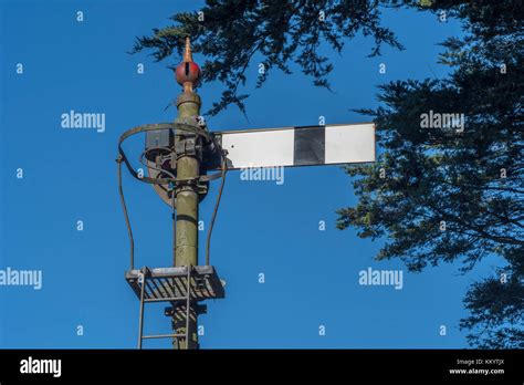 Old Style Railway Semaphore Signal In Cornwall Set Against A Bright