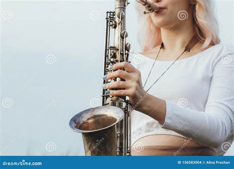 Portrait Of Young Musician On Nature Background Woman Face Playing