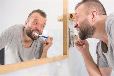 Bored Guy Brushing His Teeth In Bathroom Stock Image Image Of Brush Brushing 203872023