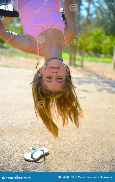 girl hanging upside down stock image image of playground 34942577