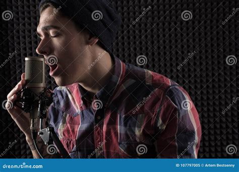 Close Up Portrait Of Emotional Young Guy Singing With His Eyes Closed