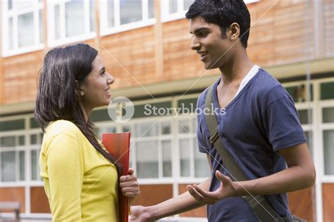 Male And Female College Students Talking On Campus Royalty Free Stock