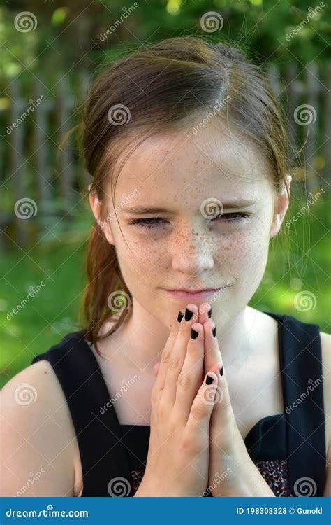 Concentrated Praying Teenage Girl Outside In Nature Stock Photo Image