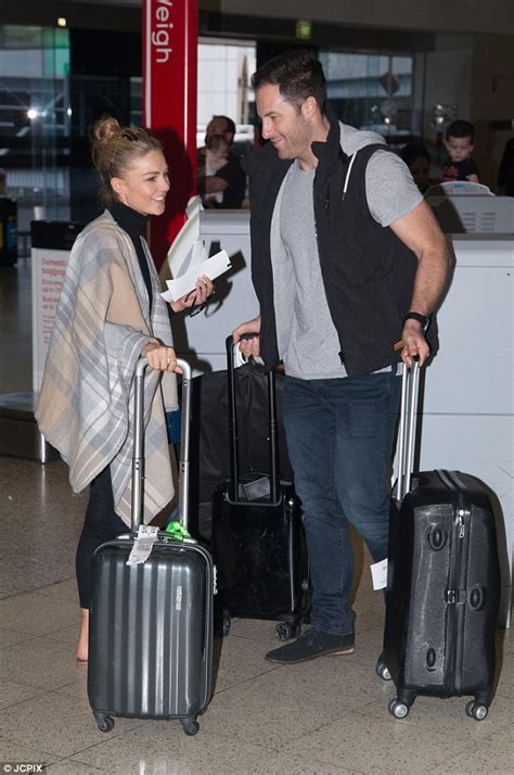 sam frost cuddles up to sasha mielczarek as they prepare to leave melbourne after logies daily