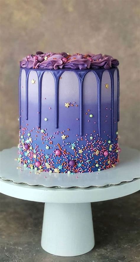 A Cake With Purple Frosting And Sprinkles