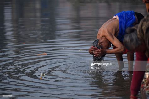 A Nepalese Hindu Devotee Takes Holy Bath In Hanumante River During