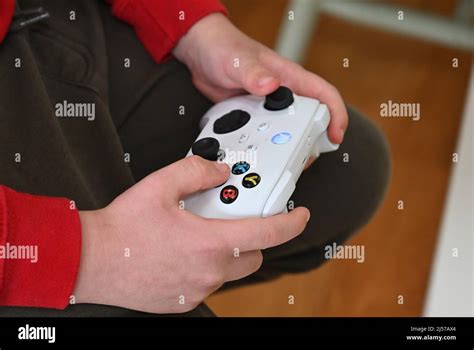 A Young Boy Holding An Xbox Controller Stock Photo Alamy