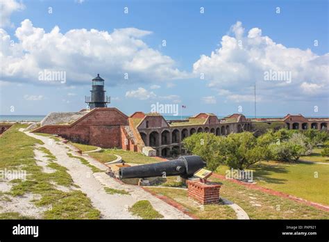 The Garden Key Lighthouse And Cannon Atop Fort Jefferson In The Dry