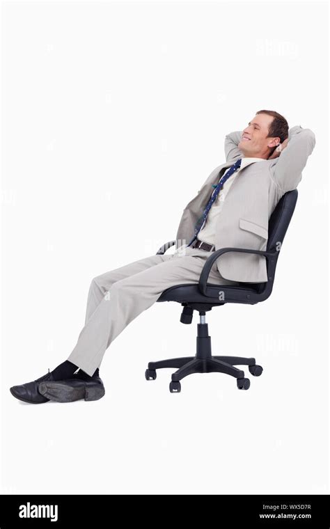 Side View Of Businessman Leaning Back In His Chair Against A White