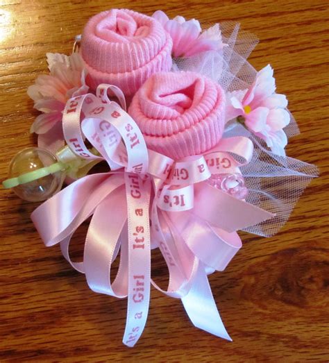 Making your corsages will make it a whole lot easier on your budget, especially if you want a corsage for every guest. Baby Sock corsage Handmade baby sock shower corsage Baby
