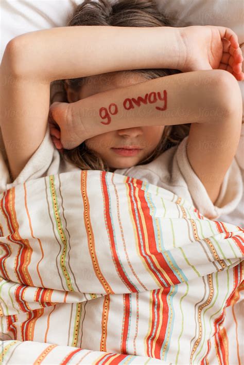 Grumpy Tween Girl Laying In Bed With The Words By Stocksy Contributor Amanda Worrall Stocksy