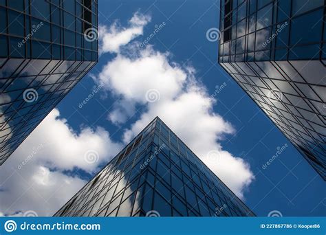 Sky And Clouds Between Modern Office Buildings Sky Reflection On