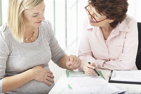 Woman Consulting Pregnant Woman Stock Image F003 6021 Science Photo Library