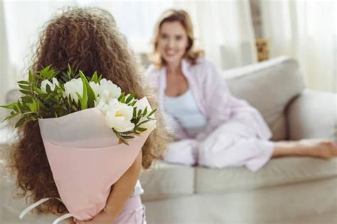 Hija Pequeña Con Ramo De Flores Para Su Madre En El Feliz Día De Las