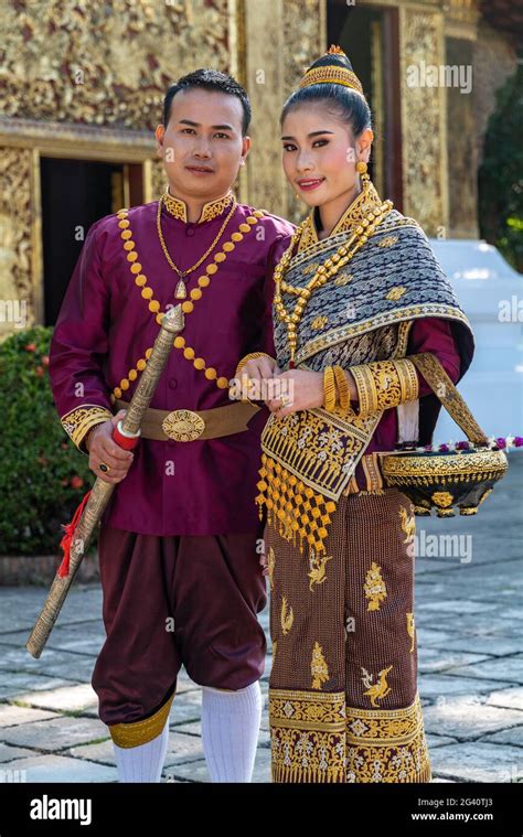 Happy Wedding Couple In Gorgeous Laotian Wedding Attire During Photo Shoot At Wat Xieng Thong