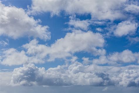 White Fluffy Clouds In A Blue Sky Beautiful Cloudscape Photo