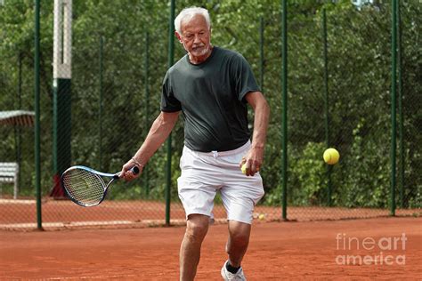 Active Senior Man Playing Tennis Photograph By Microgen Imagesscience