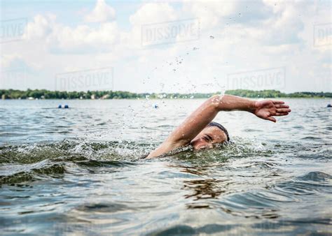 Young Girl Swimming In A Lake Stock Photo Dissolve