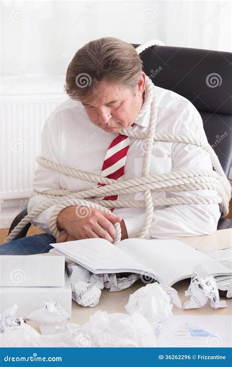 Businessman Tied Up With Rope In The Office Work Without End Stock