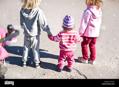 Three Girls Holding Hands Stock Photo Alamy