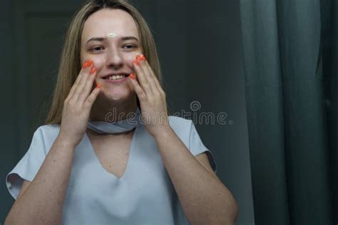 A Young Happy Woman Takes Care Of Her Face In The Morning Stock Image