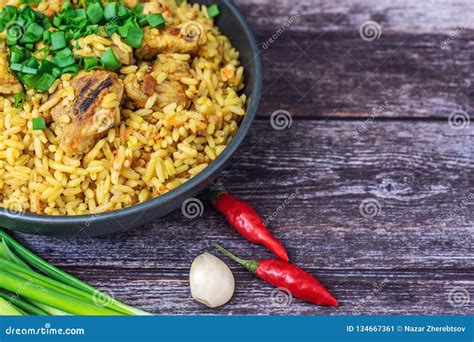 Rice Pilaf With Meat Carrot And Onion On Wooden Background Stock Image