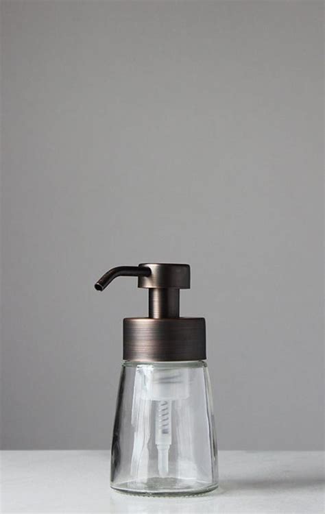 Refillable soap dispensers are great for the environment and your wallet. Small Glass Foaming Soap Dispenser with Bronze Metal Pump