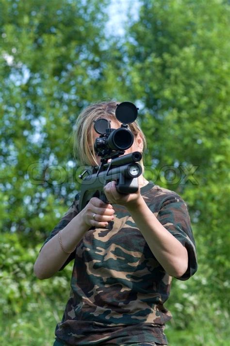 The Girl Shoots From An Air Rifle With An Optical Sight Stock Photo