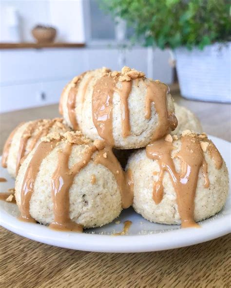 Several Biscuits Covered In Peanut Butter And Drizzled With Icing On A