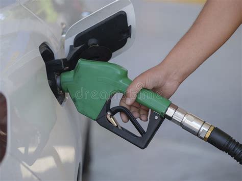 Closeup Of Man Pumping Gasoline Fuel In Car At Gas Station Stock Photo
