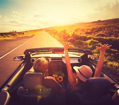 Couple Driving Convertable At Sunset Stock Photo By ©epicstockmedia